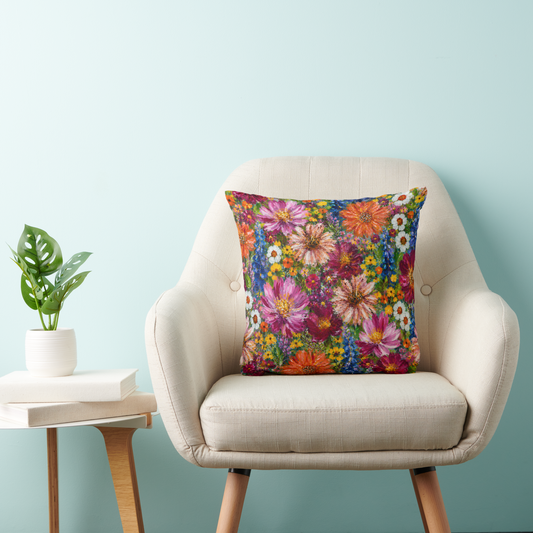 Colourful wildflower floral cushion on a cream armchair featuring original hand-painted artwork by New Zealand artist Nicky Bourke
